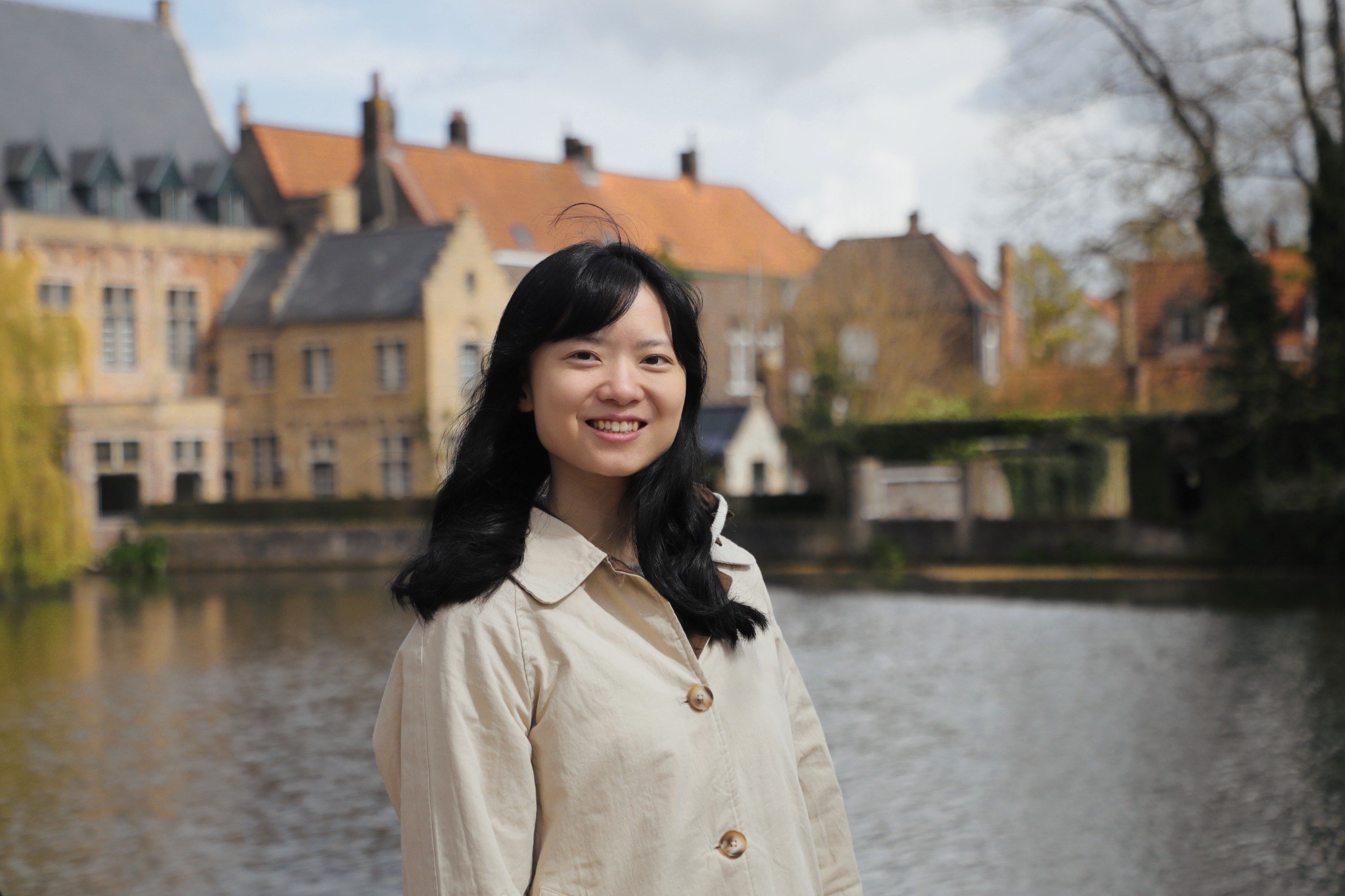 Nuo Lei standing beside a canal in front of old buildings