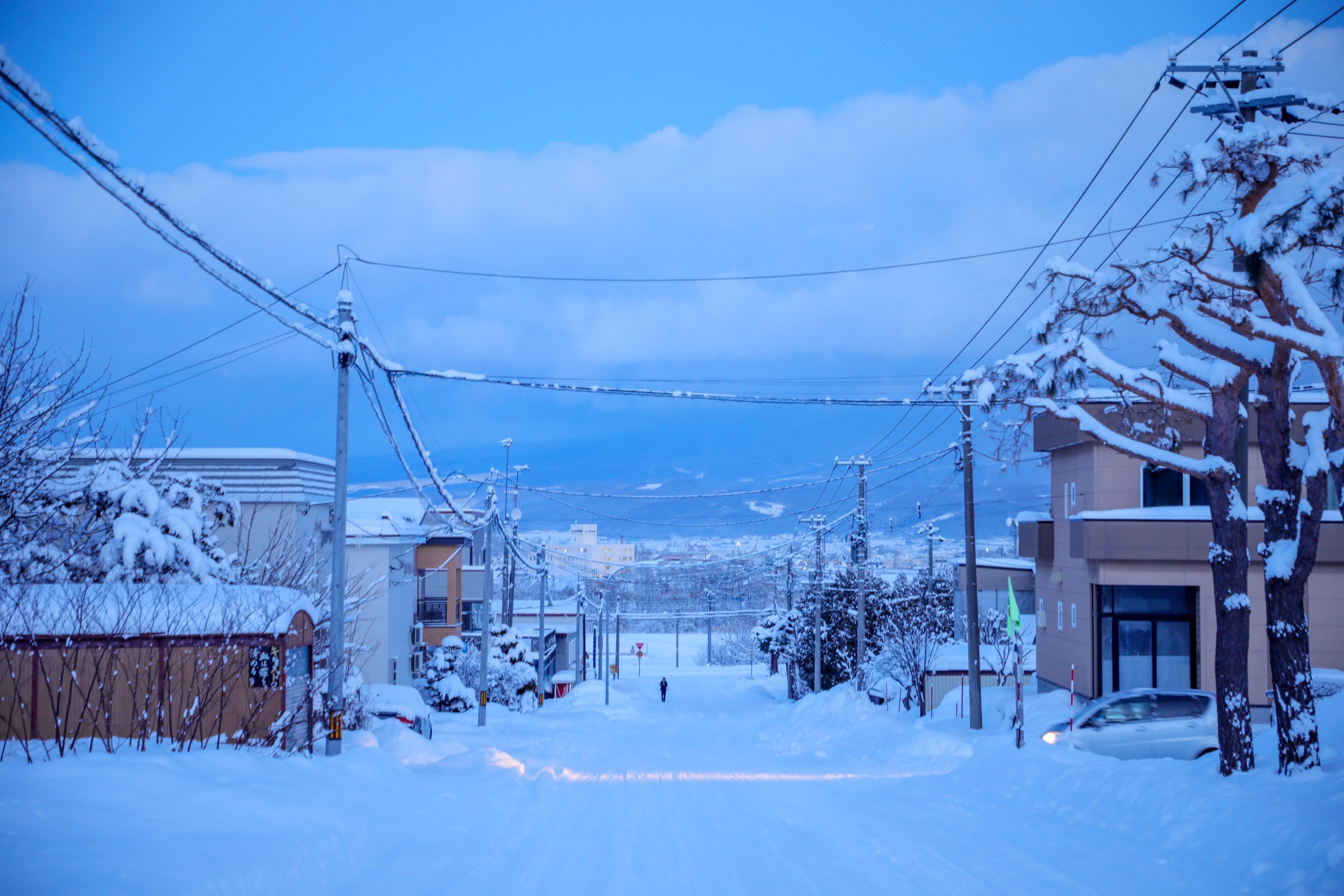 A quiet snow-covered street at blue hour