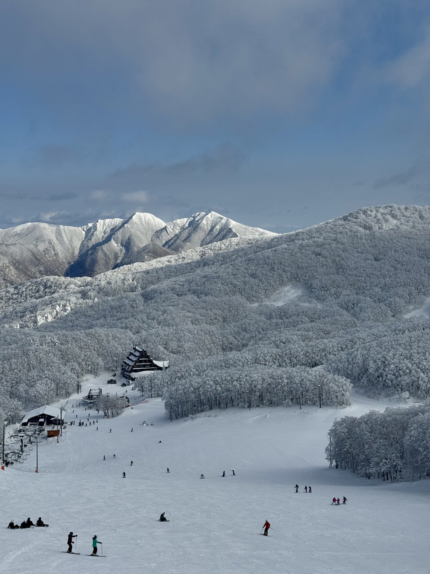 A snowy ski slope overlooking a mountain valley